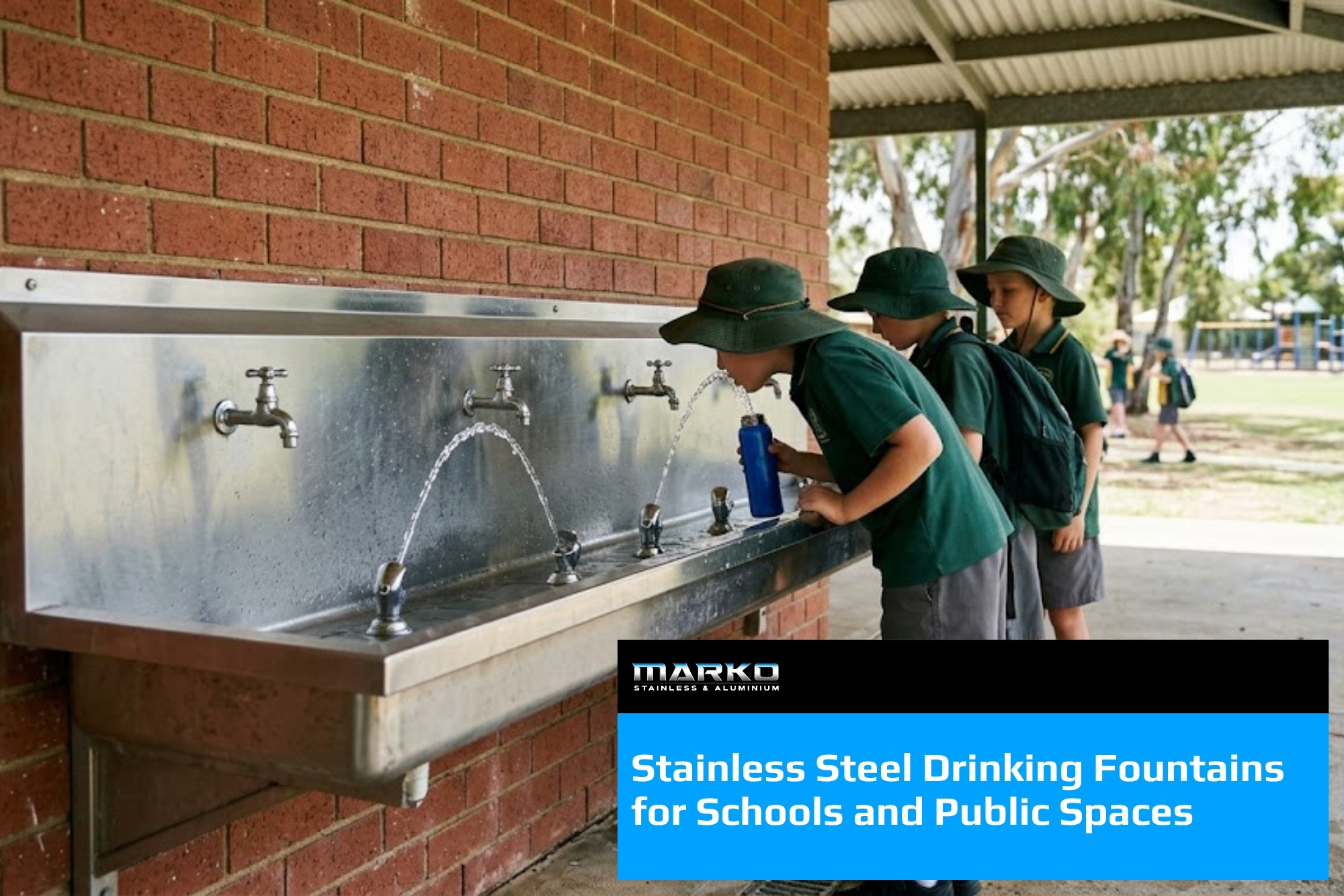 Blog - Wall mounted stainless steel drinking trough with three bubblers, used by school students beside a playground