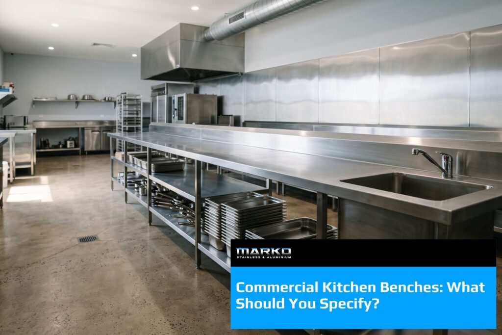 Commercial kitchen bench in stainless steel with undershelf holding gastronorm pans, plus integrated sink and tapware