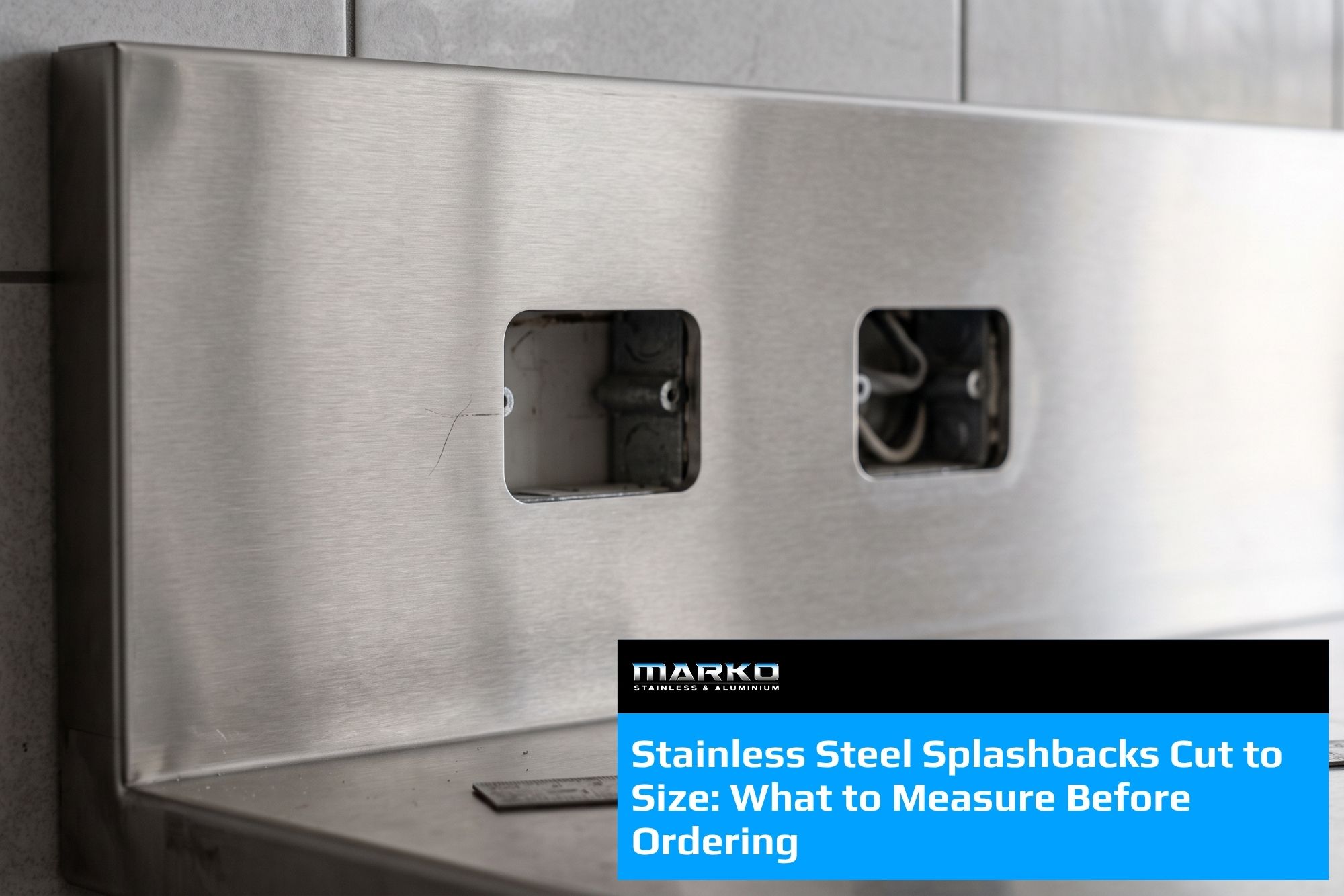 Blog - Brushed stainless steel splashback panel with folded return and service cut-outs installed above a commercial bench